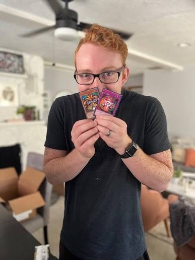 Forrest Imel holding a pair of his cards