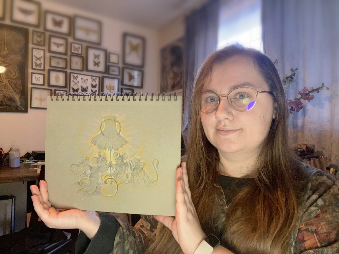 Lena Richards holding one of her graphite drawings